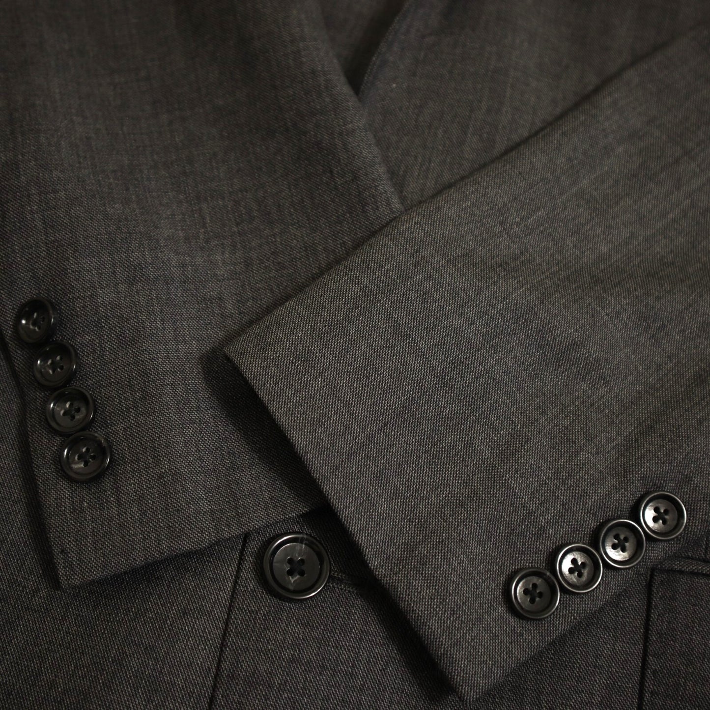 Close-up of a gray suit jacket with buttons