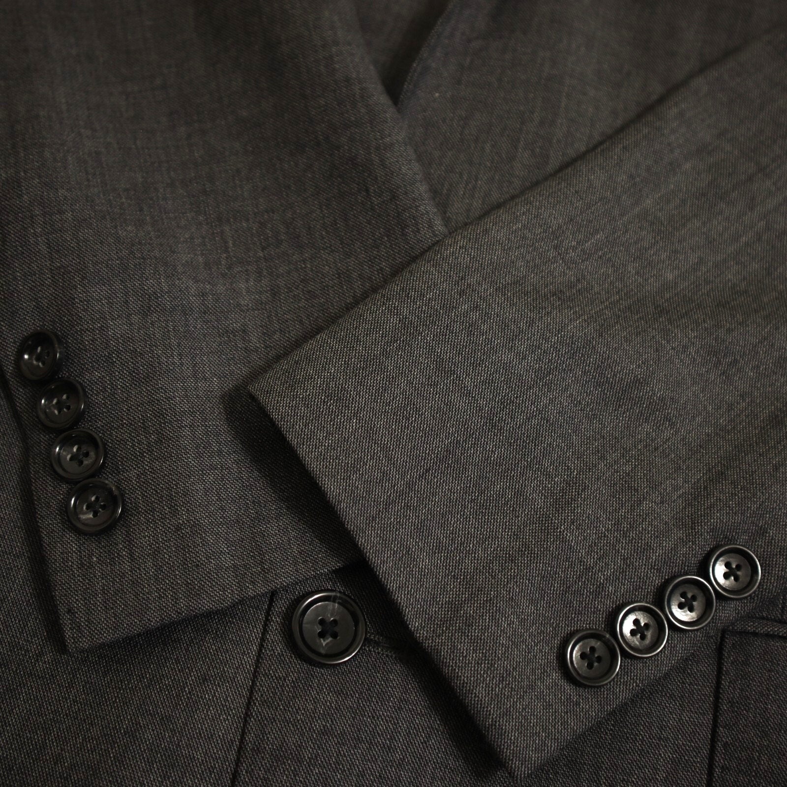Close-up of a gray suit jacket with buttons