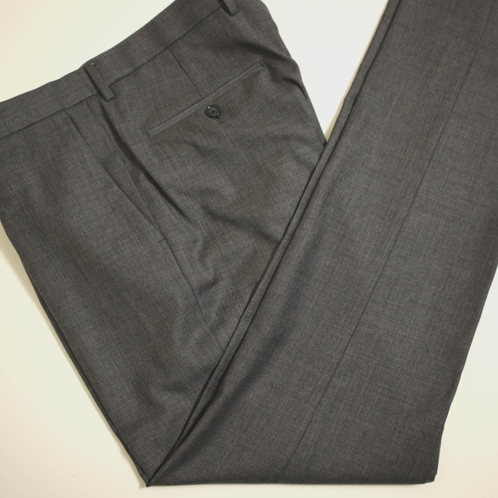 Gray suit pants on a light beige background